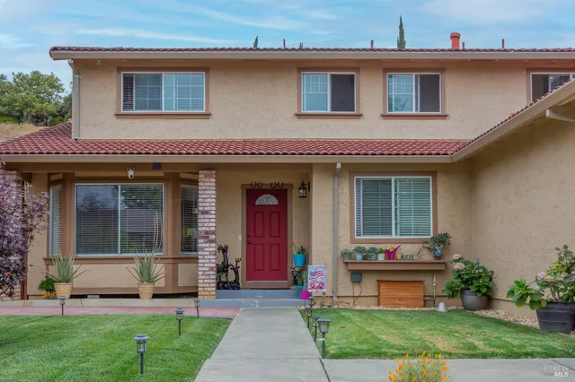 a front view of a house with garden