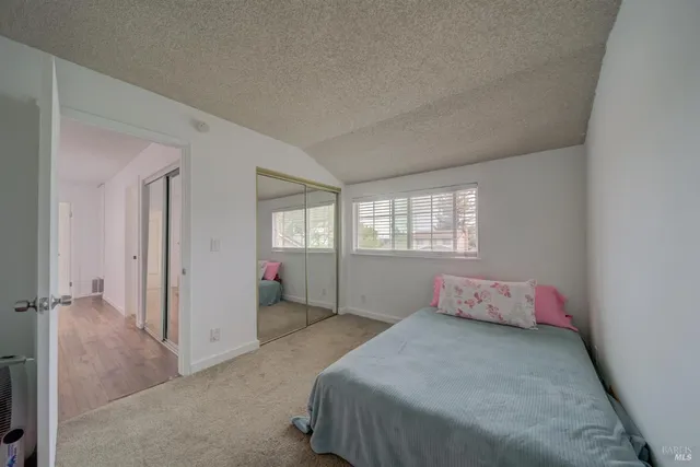 a bathroom with a granite countertop sink a toilet and a mirror