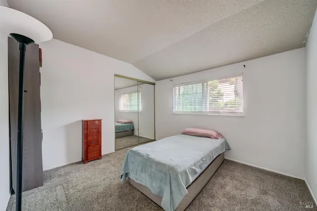 a bedroom with a bed and window
