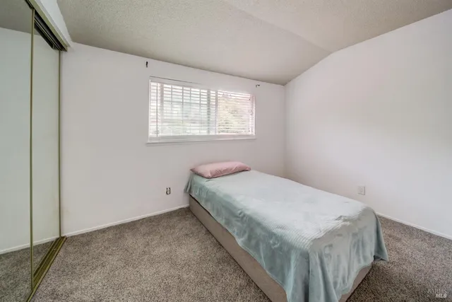 a bed room with a bed and a window