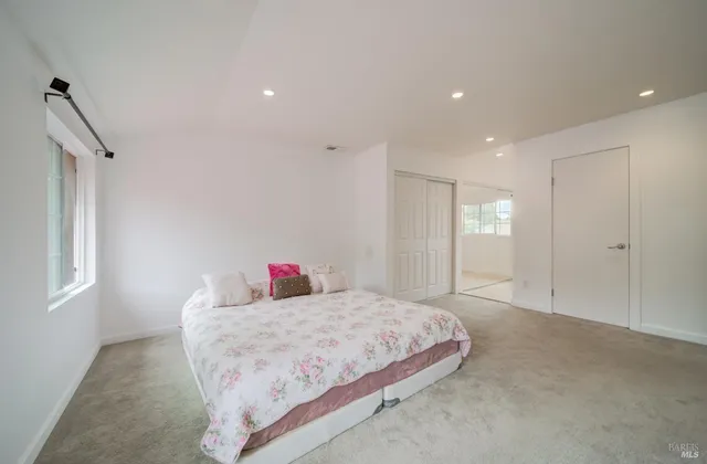 a spacious bathroom with a double vanity sink a large mirror and a shower