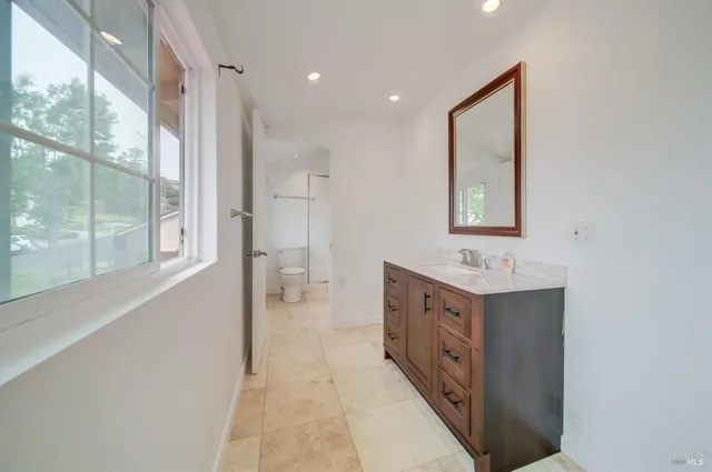 a bathroom with a sink a vanity and mirror