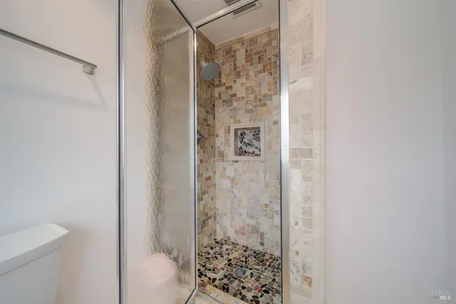 a view of a house with potted plants and a yard