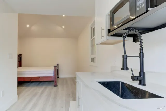 a bedroom with a bed and wooden floor