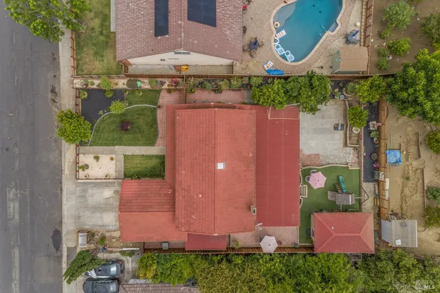 an aerial view of residential houses with outdoor space