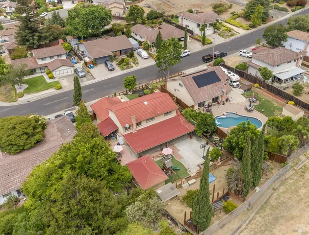 an aerial view of residential houses with outdoor space