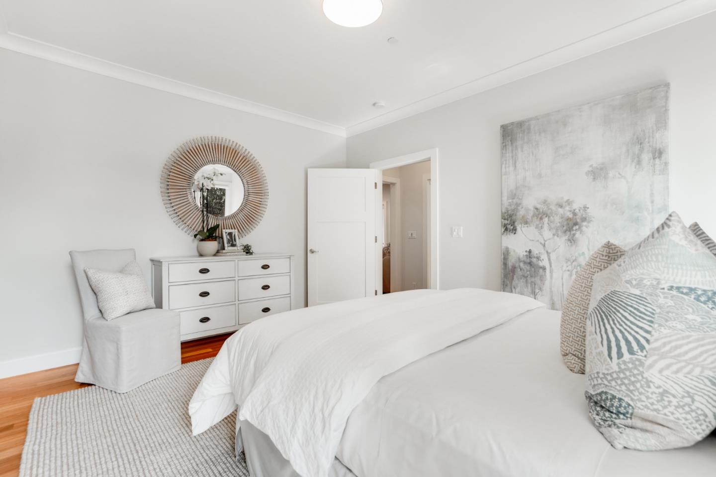 196 Merritt Road Los Altos, CA 94022 - Photo 28 of 46 a spacious bedroom with a bed and a chandelier