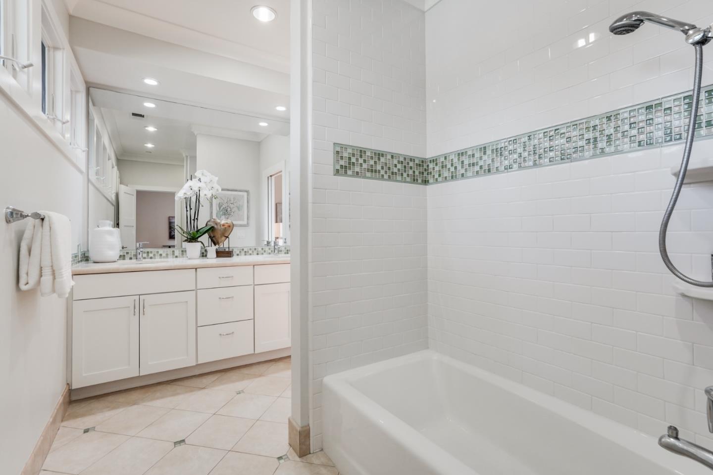196 Merritt Road Los Altos, CA 94022 - Photo 33 of 46 a bathroom with a mirror a bath tub and a shower