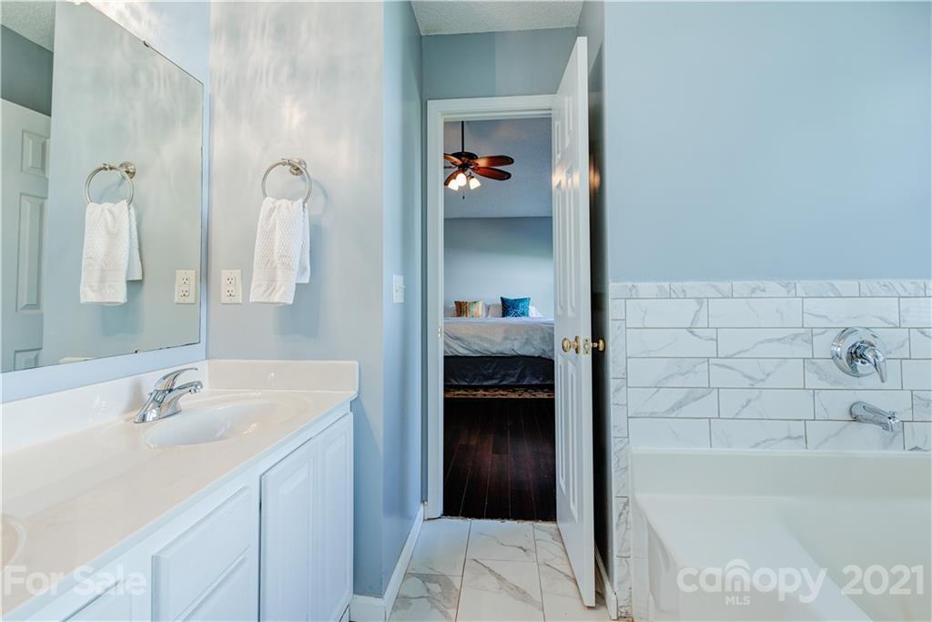 461 Planters Creek Road Fletcher, NC 28732 - Photo 14 of 26 a bathroom with a bathtub and a sink