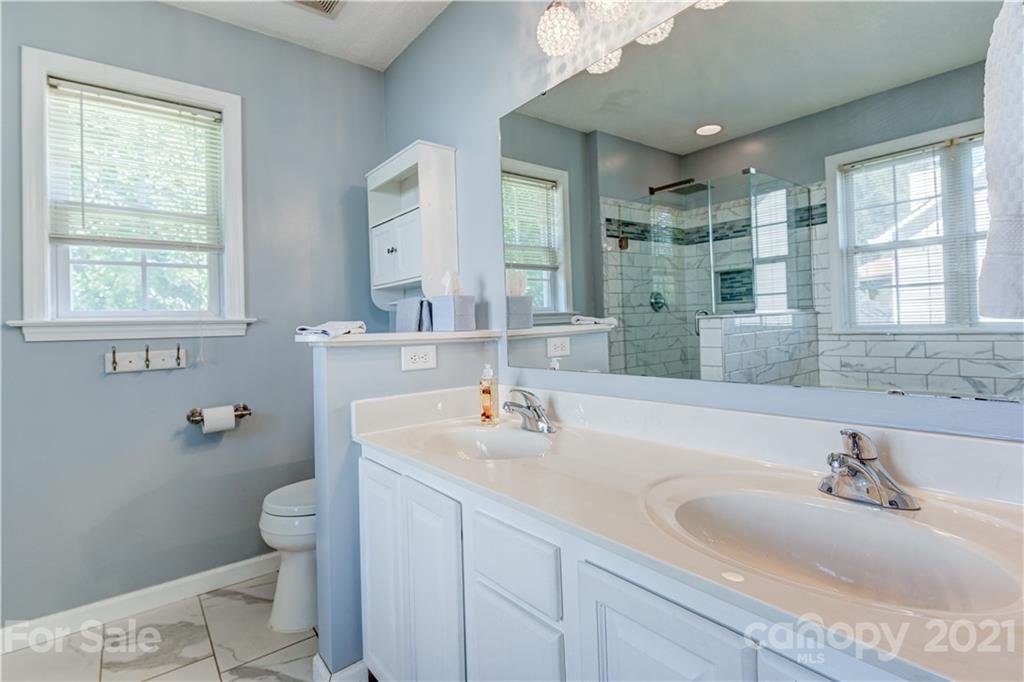 461 Planters Creek Road Fletcher, NC 28732 - Photo 15 of 26 a bathroom with a sink a toilet and a large mirror