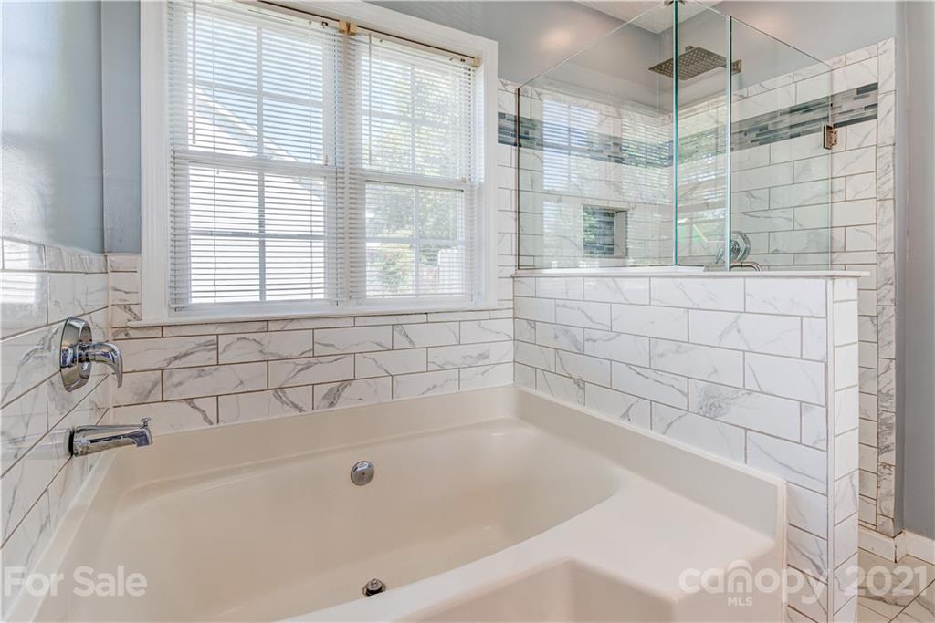 461 Planters Creek Road Fletcher, NC 28732 - Photo 16 of 26 a bathroom with a bathtub and shower