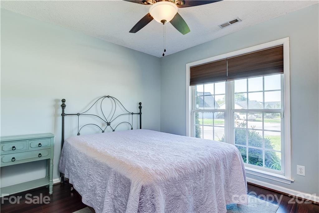 461 Planters Creek Road Fletcher, NC 28732 - Photo 17 of 26 a bedroom with a large bed and a large window