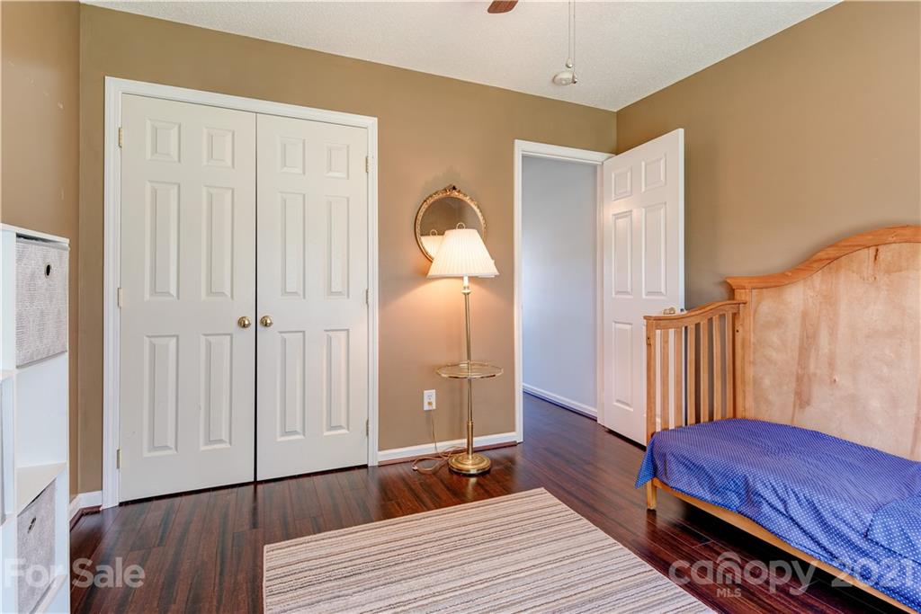 461 Planters Creek Road Fletcher, NC 28732 - Photo 19 of 26 a bedroom with a bed and a mirror