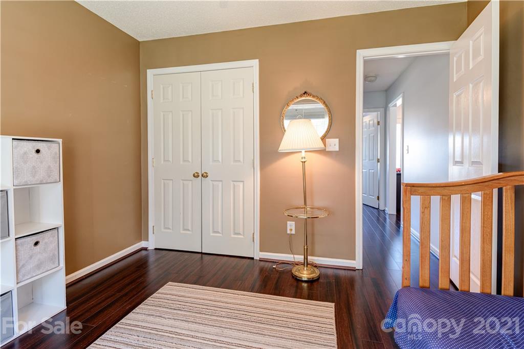 461 Planters Creek Road Fletcher, NC 28732 - Photo 20 of 26 a bedroom with a bed and wooden floor