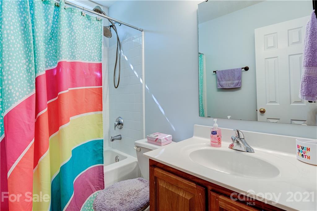 461 Planters Creek Road Fletcher, NC 28732 - Photo 21 of 26 a bathroom with a sink vanity and bathtub