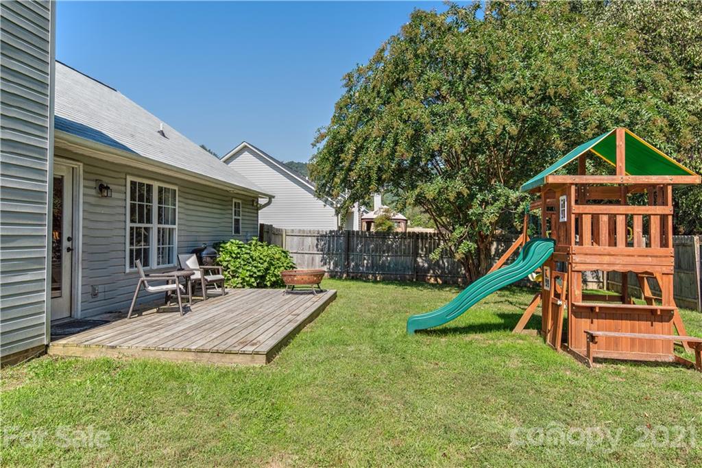 461 Planters Creek Road Fletcher, NC 28732 - Photo 24 of 26 a view of a house with a yard patio and a slide