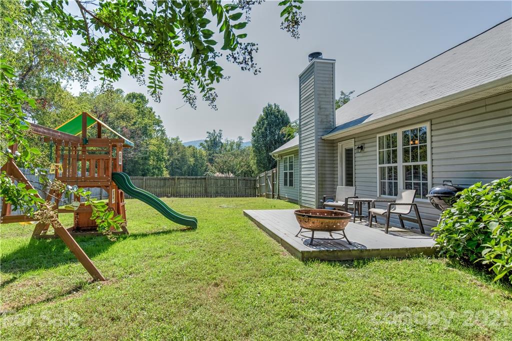 461 Planters Creek Road Fletcher, NC 28732 - Photo 25 of 26 a view of a house with a backyard and a slide