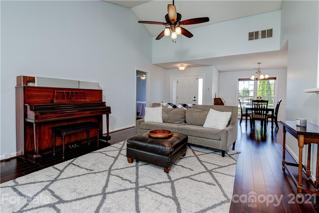 461 Planters Creek Road Fletcher, NC 28732 - Photo 5 of 26 a living room with furniture a ceiling fan a rug and a window