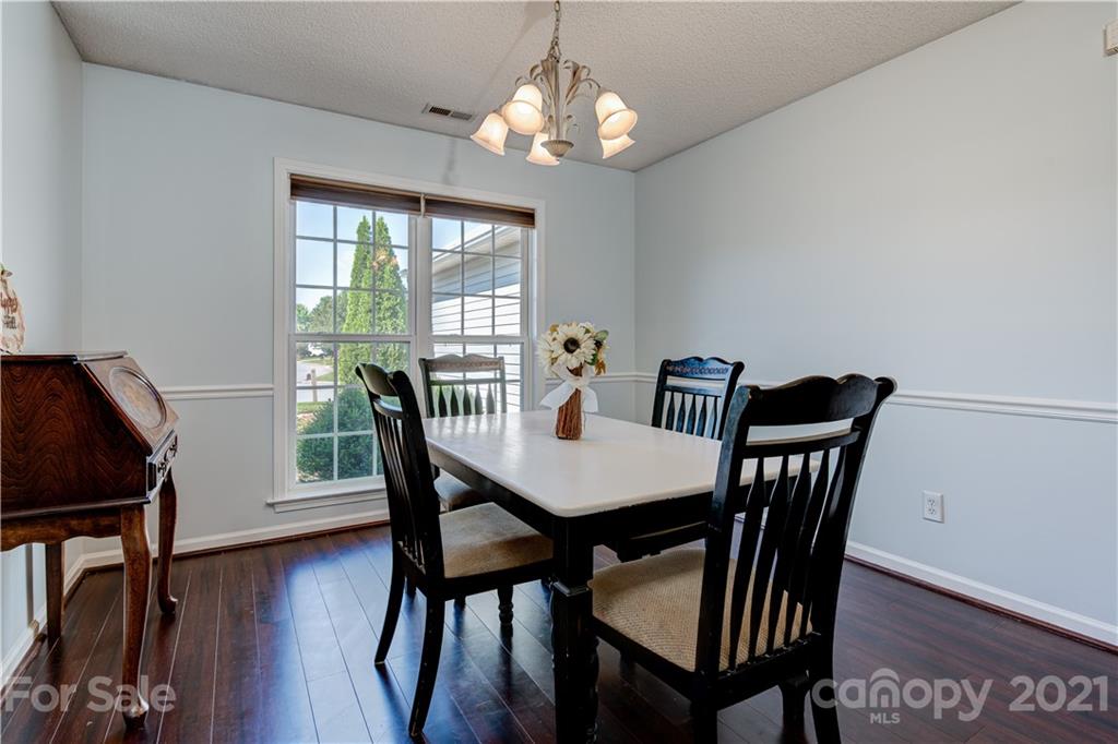461 Planters Creek Road Fletcher, NC 28732 - Photo 6 of 26 a view of a dining room with furniture window and wooden floor