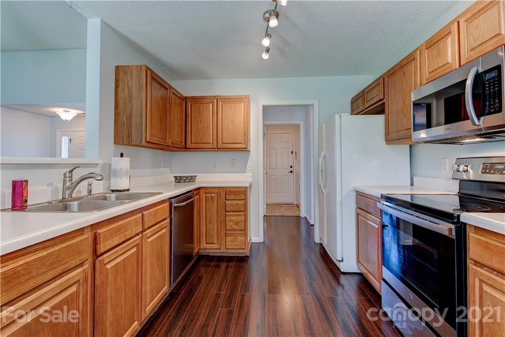 461 Planters Creek Road Fletcher, NC 28732 - Photo 7 of 26 a kitchen with stainless steel appliances granite countertop a sink stove and refrigerator