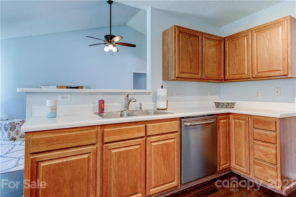 461 Planters Creek Road Fletcher, NC 28732 - Photo 9 of 26 a kitchen with stainless steel appliances granite countertop a sink and cabinets