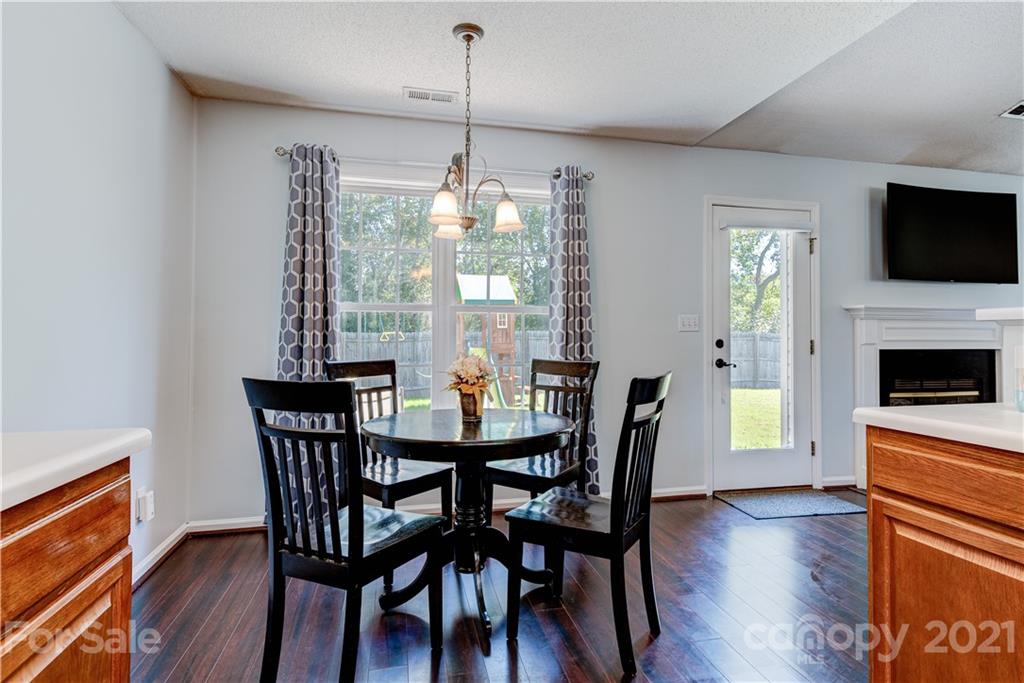461 Planters Creek Road Fletcher, NC 28732 - Photo 10 of 26 a view of a dining room with furniture wooden floor and chandelier