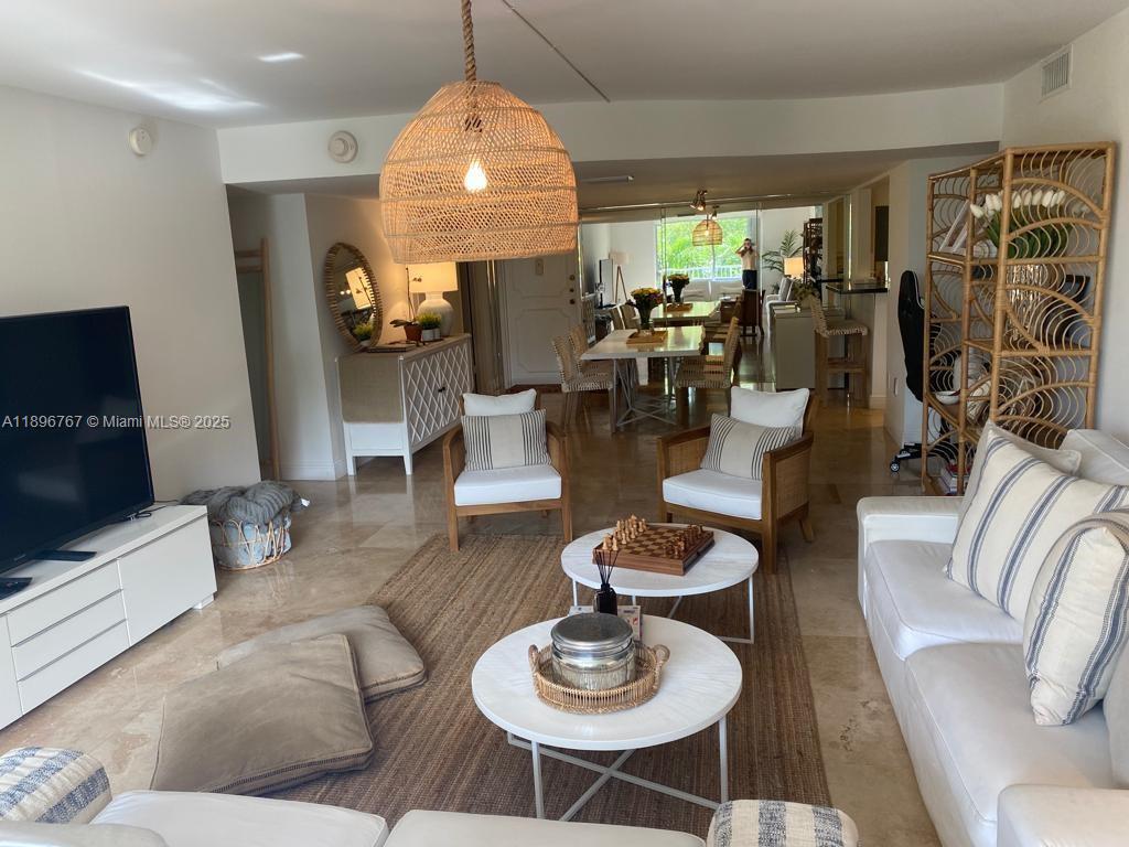 a living room with fireplace furniture and a flat screen tv