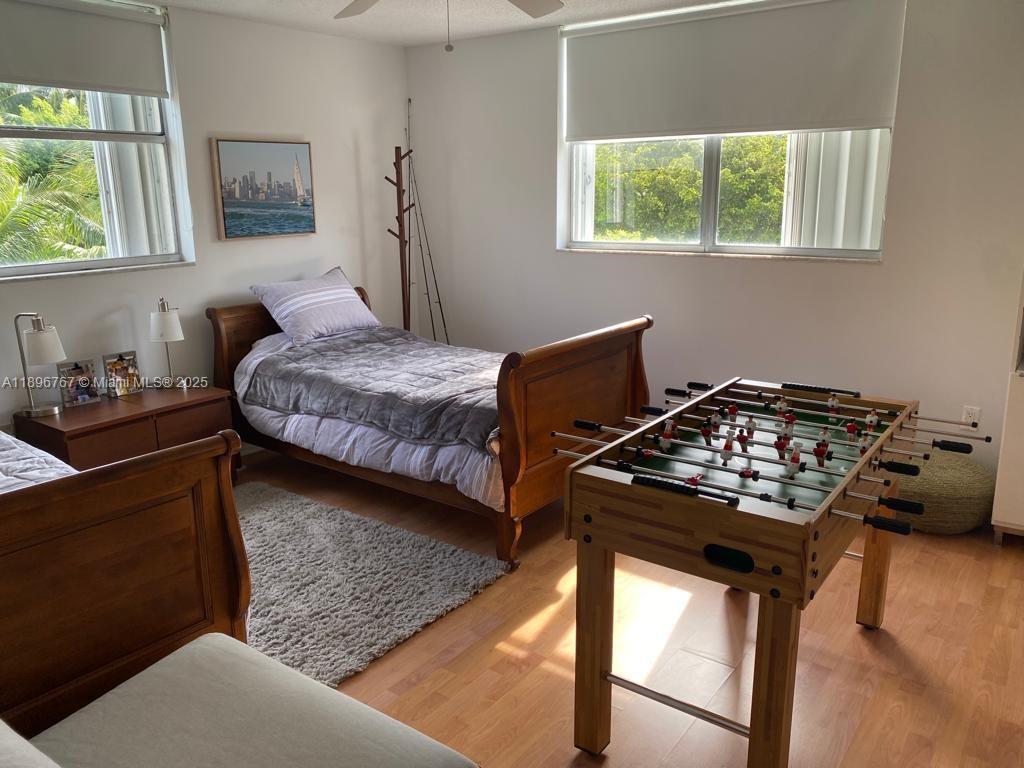 210 Seaview Drive, Unit 312 Key Biscayne, FL 33149 - Photo 13 of 26 a bedroom with a bed and a window