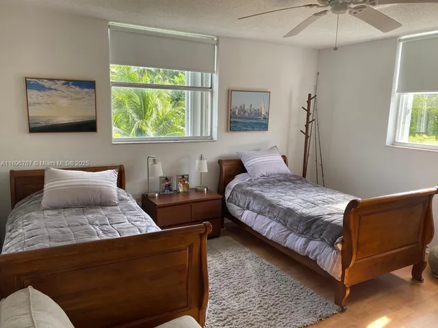 a bedroom with a bed window and couch