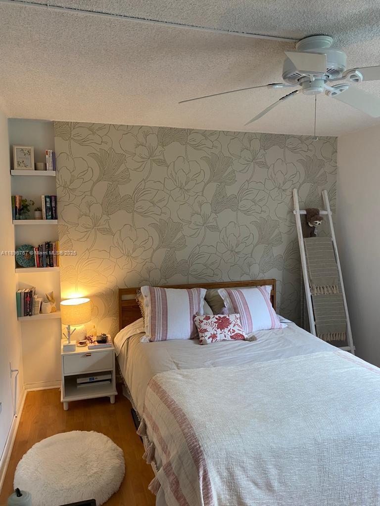 210 Seaview Drive, Unit 312 Key Biscayne, FL 33149 - Photo 19 of 26 a bedroom with a bed and a couch