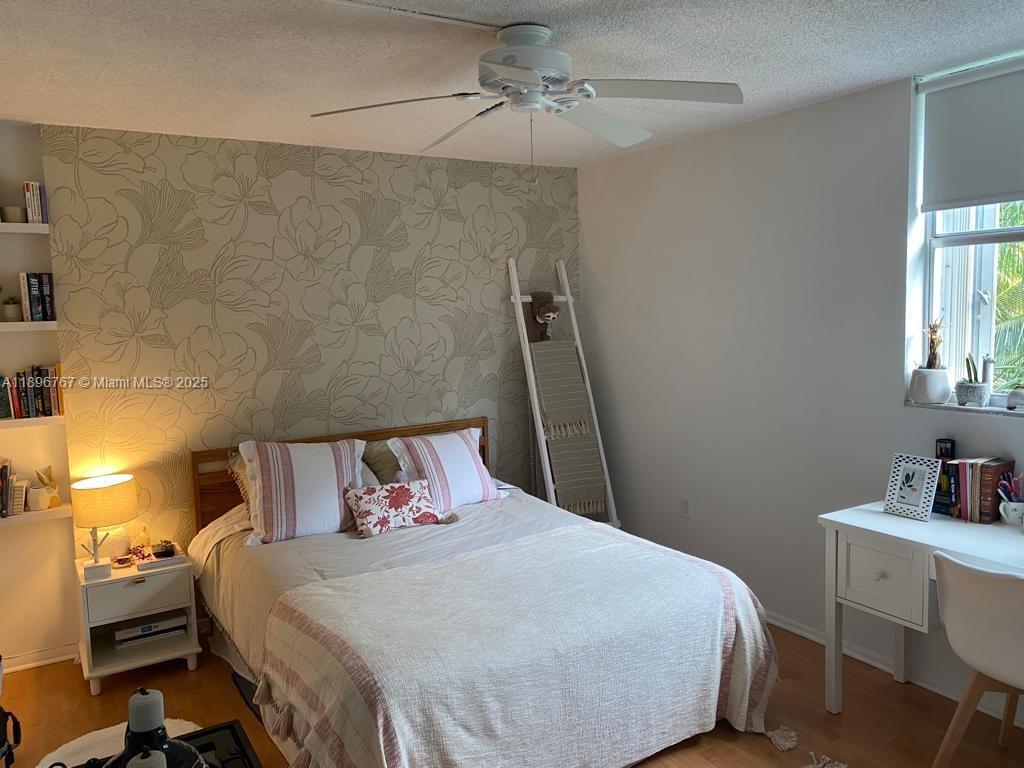 210 Seaview Drive, Unit 312 Key Biscayne, FL 33149 - Photo 20 of 26 a bedroom with a bed and a window