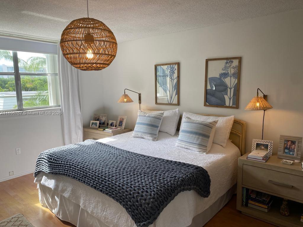 210 Seaview Drive, Unit 312 Key Biscayne, FL 33149 - Photo 22 of 26 a bedroom with bed and a window