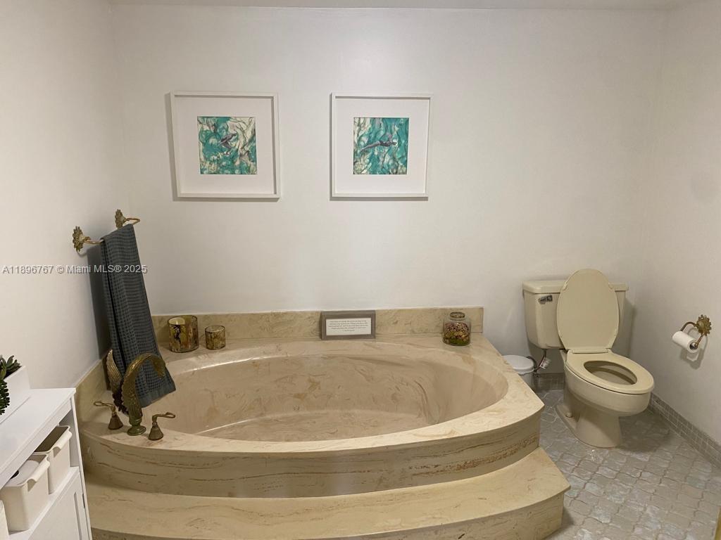 210 Seaview Drive, Unit 312 Key Biscayne, FL 33149 - Photo 24 of 26 a bath tub sitting next to a white toilet
