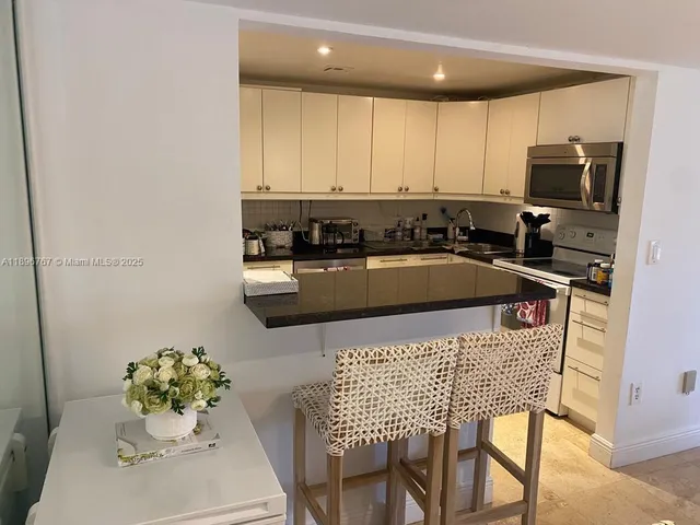 a kitchen with a table chair and microwave