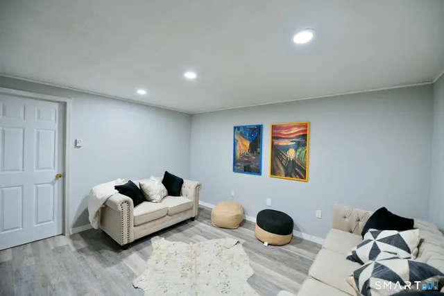 a living room with furniture and wall painting