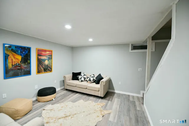 a living room with couches and a rug