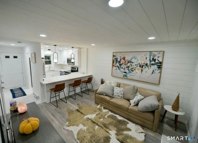 a living room with furniture and kitchen view