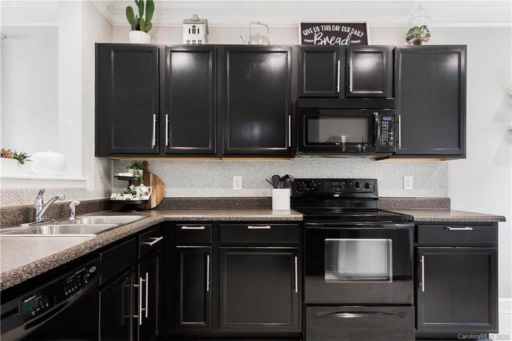4002 Farm Pond Road Indian Trail, NC 28079 - Photo 11 of 32 a kitchen with a sink and a microwave