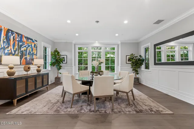 a dining room with furniture a rug and wooden floor