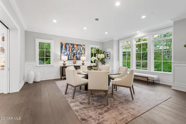 a dining room with furniture and a window