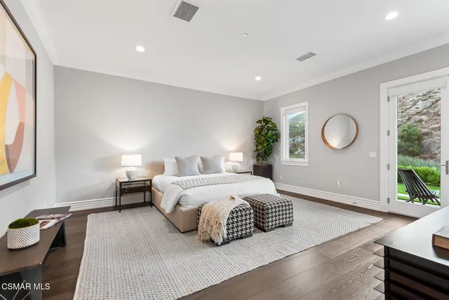a bedroom with a bed and a large window