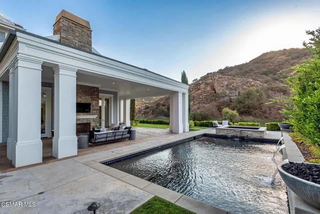 a view of a chairs and table in the backyard