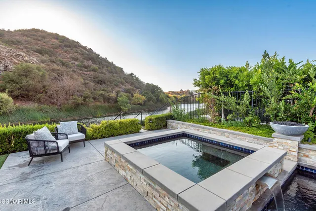 a view of a patio with couches table and chairs and potted plants