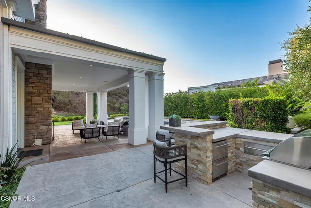 a outdoor living space with furniture potted plant and a large window