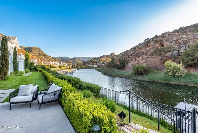 a view of a house with a yard and a patio