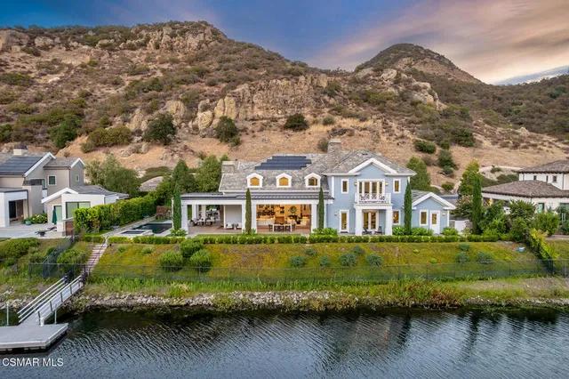 an aerial view of residential houses with outdoor space and pool