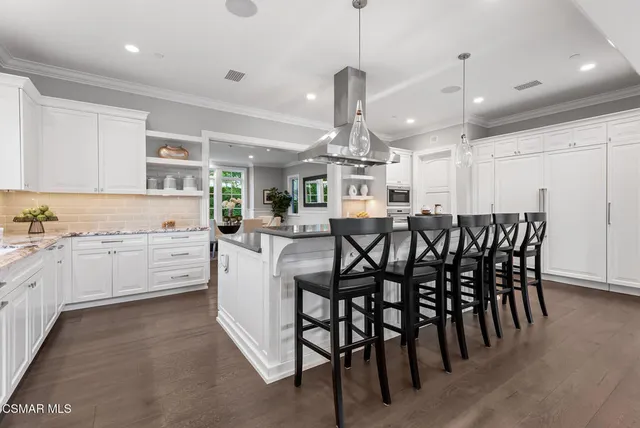 a large kitchen with a table and chairs