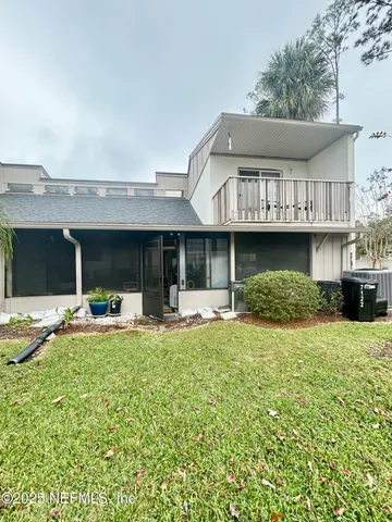 a front view of a house with swimming pool and furniture