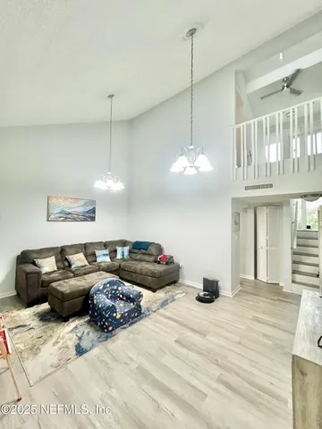 a bedroom with bed and a chandelier