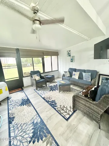 a view of a living room and kitchen